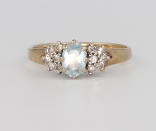 A 9ct yellow gold diamond and aquamarine ring, 2 grams, size L