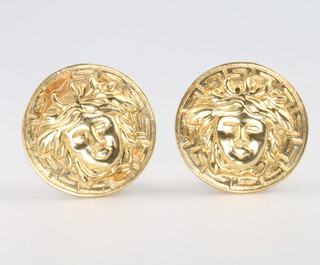 A pair of 18ct yellow gold mask ear clips, 8.6 grams 