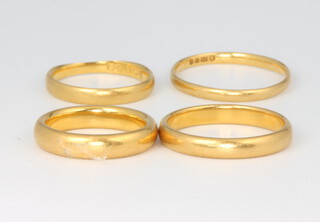 Four 22ct yellow gold wedding bands size G, H, N and O 1/2, 14 grams 