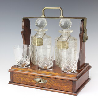 An Edwardian plated mounted 2 bottle tantalus with fitted drawer and 3 later glasses 
