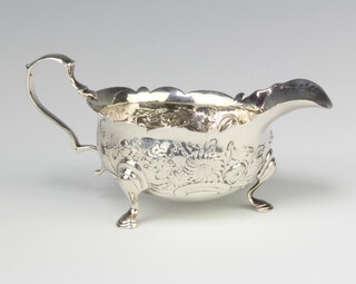 A George II repousse silver sauce boat with floral decoration and chased monogram, London 1732, 94 grams, 13cm 