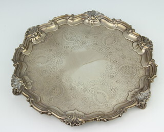 A Georgian style silver salver with shell and scroll rim enclosed by scrolling flowers on scroll feet, London 1900, 26cm, 694 grams  
