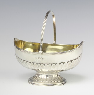 A Victorian demi-fluted silver boat shaped sugar bowl with swing handle, Sheffield 1893, 13cm, 146 grams