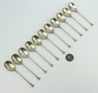 Eleven silver teaspoons, Sheffield 1932 and a drilled shilling, 132 grams