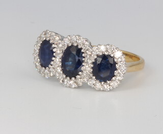 An 18ct yellow gold triple sapphire and diamond cluster ring, sapphire 1.88ct, diamonds 0.7ct, size N 
