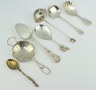A George III silver caddy spoon with shell bowl, rubbed marks and minor spoons, 150 grams 