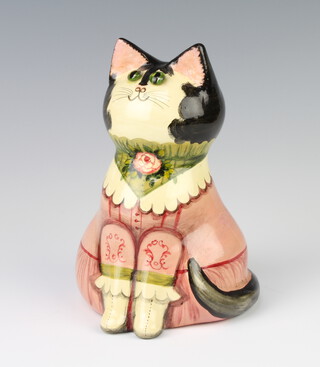 A Rye Pottery cat designed by Joan and David De Bethel wearing a dress with glass eyes, inscribed on the base 18cm 