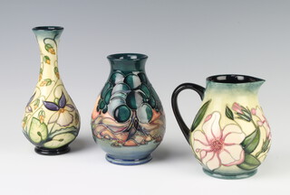 A modern Moorcroft baluster vase, the cream ground decorated Sweet Theif design by Rachel Bishop, circa 2000, impressed marks 17cm, ditto baluster jug decorated Mamoura design by Sally Tuffin 14cm and a baluster jug decorated with flowers 12cm 