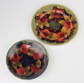 Two Walter Moorcroft shallow dishes decorated with pomegranate design 17cm and 14cm diam