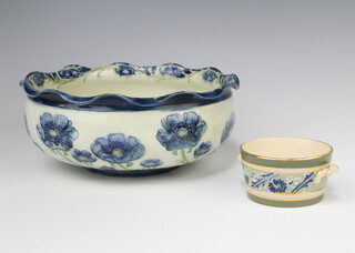 A William Moorcroft Florian Ware shallow bowl decorated with the poppy design and with wavy rim, base with printed and signature marks 23cm together with a gesso faience dish 10cm 