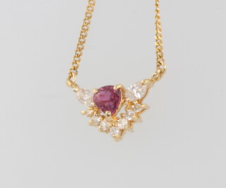 An 18ct yellow gold diamond and ruby pendant and chain, the diamond approx. 0.44ct