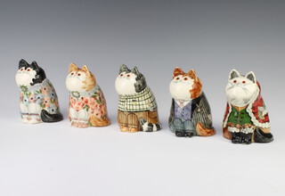 A Rye Pottery cat from an original design by Joan De Bethel, with glass eyes, decorated with flowers 13cm, a Rye Father Christmas cat 13cm, ditto cat with floral dress 13cm, ditto gardening cat 13cm and another wearing a pinstriped suit 13cm 