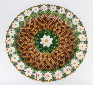 A Victorian Minton Majolica shallow dish decorated with formal flowers and basket weave interior, impressed marks 41cm 