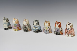 Seven Rye Pottery figures of seated dressed cats with painted eyes 8cm 