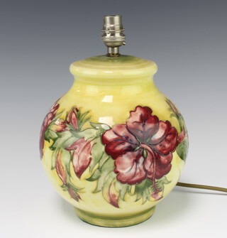 A Moorcroft yellow ground globular table lamp decorated with Hibiscus design, the base with impressed mark and paper label 21cm 