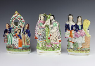 A Victorian Staffordshire watch holder supported by 3 ladies 28cm, a ditto of a couple holding corn 23cm and a spill vase 25cm 