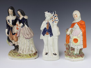 A Victorian Staffordshire group of a lady and gentleman holding a dog 33cm, a ditto of a lady 28cm and a figure of a man 28cm 