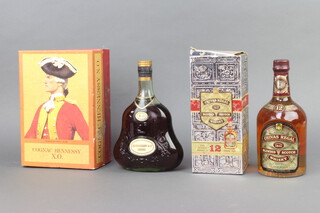 A bottle of Hennessy XO Cognac, together with a bottle of Chivas Regal blended Scotch whisky, both boxed

  