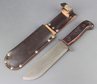 A British Army issue survival knife, blade marked 127/8214 with leather scabbard 