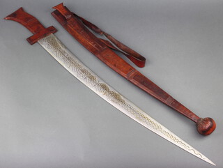 An Eastern sword with 71cm curved and etched blade complete with leather scabbard 