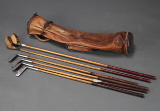 Two Fred Saunders of Highgate hickory shafted golf drivers together with 4 Fred Saunders of Highgate hickory shafted golf clubs - The Wonder Putter, The Wonder Mashie Niblick, The Knacky Iron 3 and The Wonder Mashie, all contained in a leather carrying case 