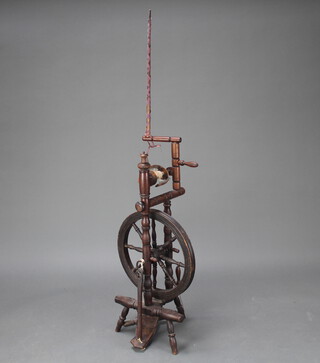 A 19th Century elm spinning wheel with later parts 96cm x 29cm x 43cm 