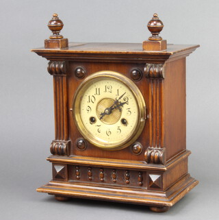 A 19th Century Continental 8 day striking bracket clock with paper dial and Arabic numerals contained in a walnut case, the back plate marked 56009, complete with pendulum and key 