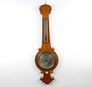 A 19th Century mercury barometer and thermometer with silvered dial, contained in a light oak wheel shaped case 