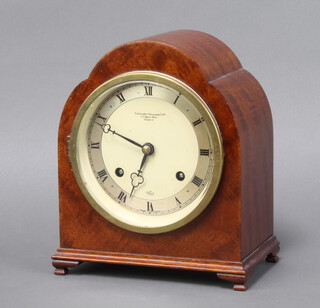 Elliott for The Goldsmiths and Silversmiths Company, a striking mantel clock with silvered dial and Arabic numerals contained in an arch shaped walnut case complete with pendulum and key, the back plate marked 6924 