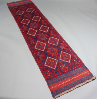 A blue and red ground Mashwani runner with 15 diamonds to the centre 255cm x 63cm 