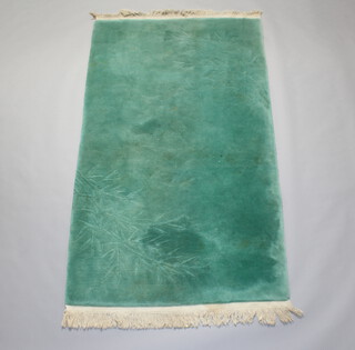 A green ground sculpted Chinese rug with bamboo decoration 221cm x 125cm 