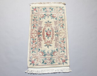 A white and floral patterned Chinese rug 129cm x 96cm 