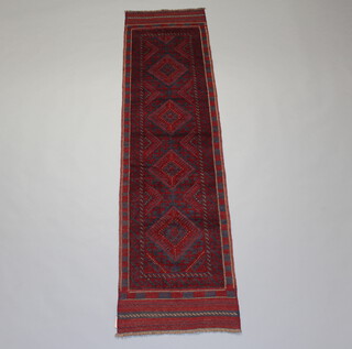 A blue and red ground Meshwani runner with 4 diamonds to the centre within a multi row border 255cm x 64cm 