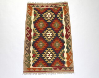 A black, brown and white ground Maimana Kilim rug with all over geometric design 134cm x 81cm 