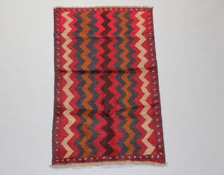 A blue, black and red ground Belouche rug with wavy design 132cm x 80cm 