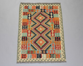 A green, black and orange ground Chobi Kilim rug with geometric designs 142cm x 100cm 
