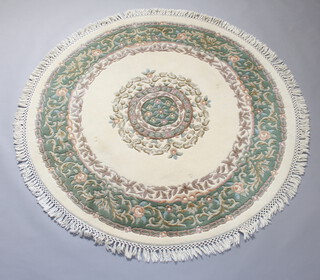 A circular white and green floral patterned Indian rug 178cm diam. 