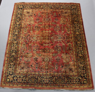 A pink, gold and blue ground Persian carpet, floral patterned within a multi row border 311cm x 142cm  