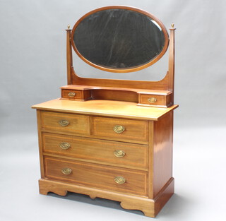 An Edwardian bleached inlaid mahogany dressing chest with oval bevelled plate mirror, fitted 2 glove drawers above 2 short and 2 long drawers, raised on bracket feet 156cm h x 106cm w x 51cm d 