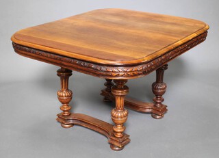 A 19th Century Continental walnut dining table raised on 4 turned and fluted columns with carved apron 70cm h x 114cm w x 104cm d 