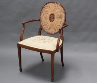 A Georgian style mahogany open armchair with cane work back and Berlin wool work seat, raised on square tapered supports 