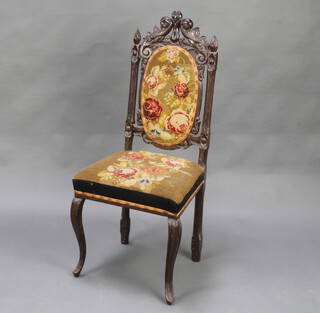 A Victorian Continental carved oak hall chair, the seat and back upholstered in tapestry material, raised on cabriole supports (frame loose) 