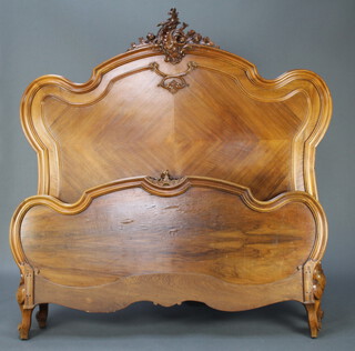 A 19th Century French carved walnut double bedstead complete with associated side irons 170cm h x 160cm w x 210cm l 