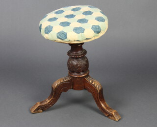 A Victorian carved walnut revolving piano stool raised on carved cabriole supports 46cm h x 21cm 