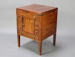 A Georgian mahogany enclosed wash stand with hinged top, the base enclosed by a panelled door flanked by 4 short and 1 long drawers, raised on square tapered supports 75cm h x 53cm w x 50cm d 