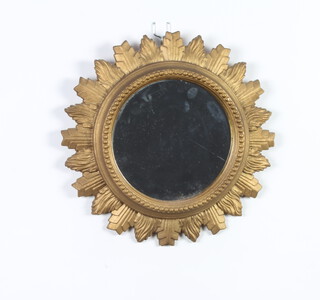 A Georgian style circular mirror contained in a carved oak sunburst frame 31cm diam. 
