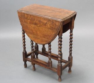 A light oak oval drop flap gateleg tea table, raised on spiral turned supports 73cm h x 59cm w x 31cm when closed x 89cm when open 