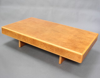 An Art Deco style rectangular figured walnut coffee table raised on panel supports 37cm h x 159cm w x 94cm d 