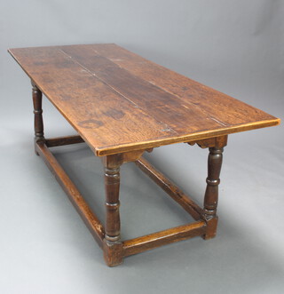 A 17th/18th Century oak refectory dining table, the top formed of 3 planks raised on turned and block supports with box framed stretcher, the apron marked L R 77cm h x 205cm l x 87cm w  