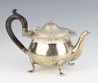 A silver teapot with hoof feet and ebony handle, London 1919, gross 378 grams 